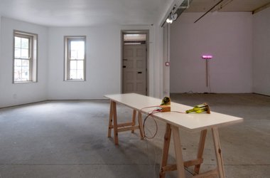 Force Things installed at Gallery Three. On the far wall is Fibre Optic Broom, 2010, by Eddie Clemens. On the table is Soap Box by Michael Grobelny