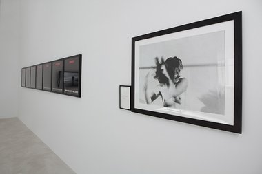 Installation of RE:VISION at Trish Clark Gallery. On the left, Alfredo Jaar's Tonight No Poetry Will Serve; on the right, Marina Abramovic's Art Must Be Beautiful, Artist Must Be Beautiful, 1975; publ. 1994, black and white photograph with text panel