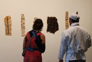 Visitors to the gallery examine some of the paintings produced by Hindin's wananga aute. 