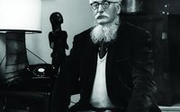 William Empson posing with an unidentified sculpture.